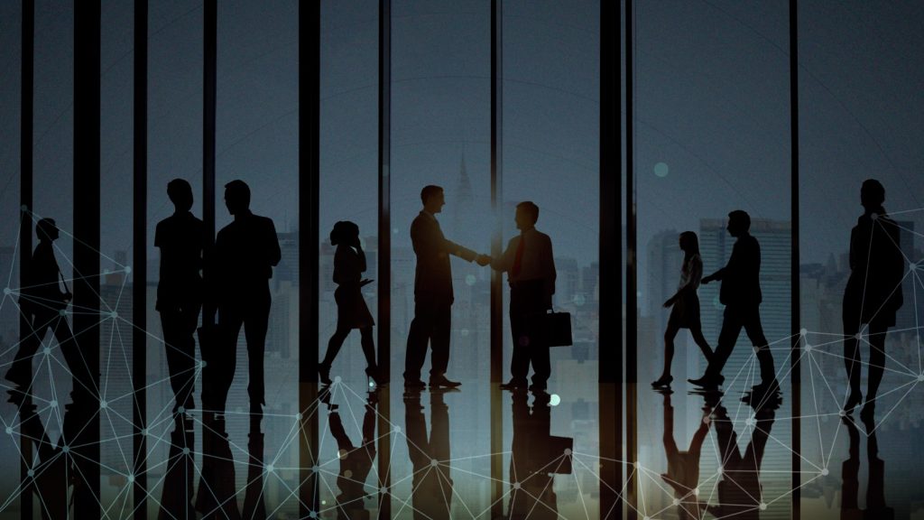 Future-focused business collaboration with a city skyline in the background.
